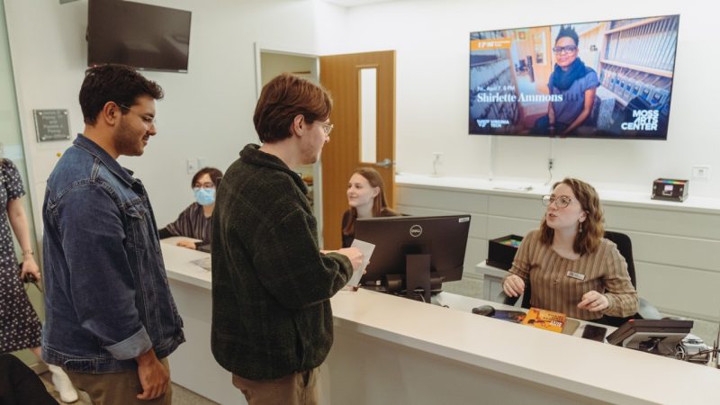 Student employees assist patrons at the Moss Arts Center box office.