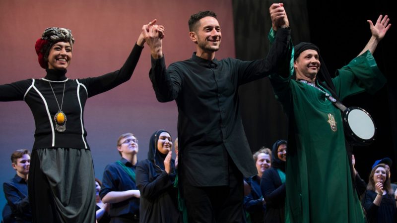  Visiting artists Saba Taj, Omar Offendum, and Karim Nagi hold hands to take a bow during the culminating performance of Salaam: Exploring Muslim Cultures at the Moss Arts Center