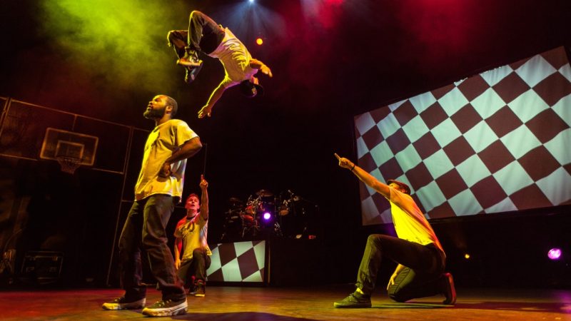 360-allstars_matt-loncar2 Members of 360 ALLSTARS perform on stage, one man flipping backwards high in the air over another cast member.