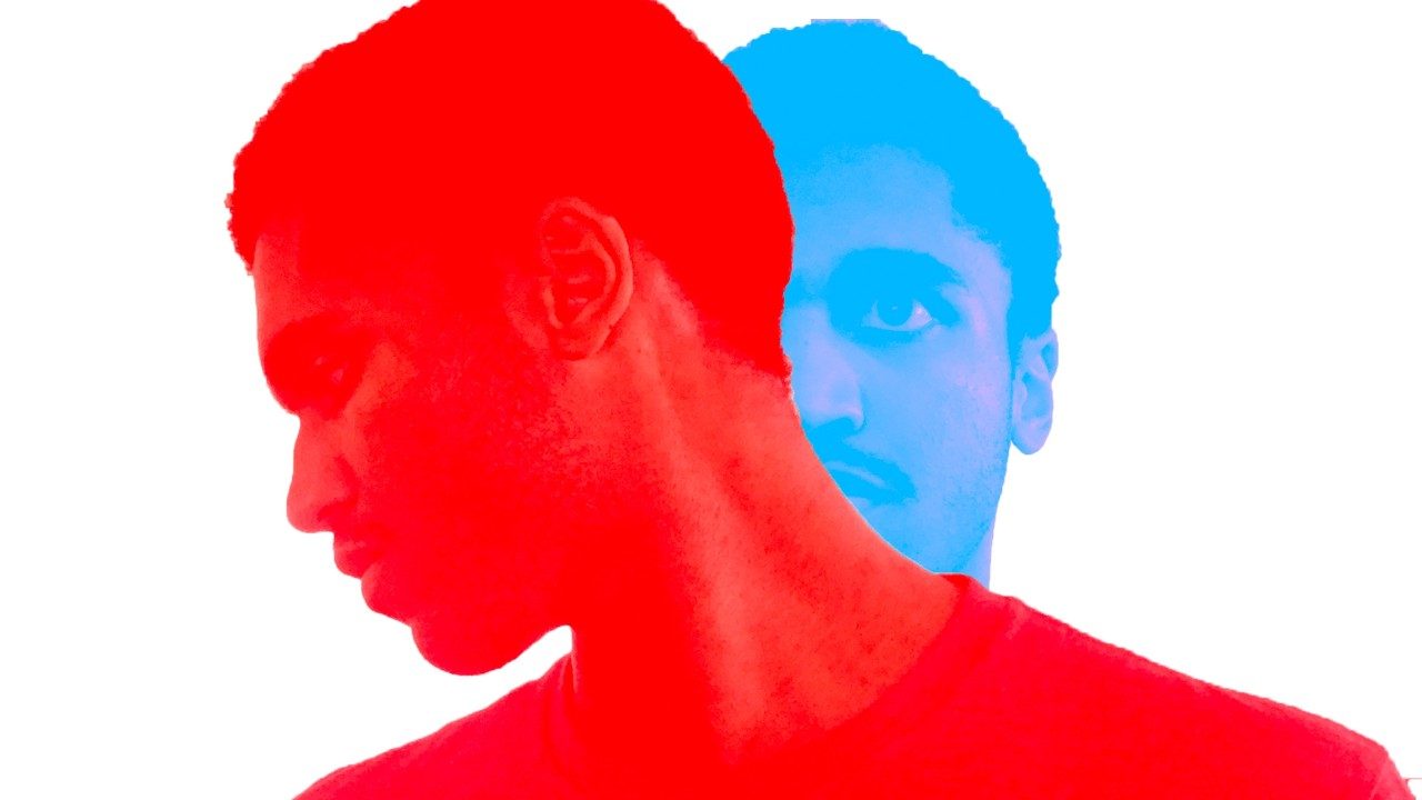  A photoshopped image by Jeremy Grant. Two photos of a Black man with short natural hair and a T-shirt are overlaid on each other against and white background. The image in the foreground is red, and the man looks to his right and down. The image in the back is blue and the man looks ahead towards the camera. The red image covers the blue so all you can see is the left half of the man's face.
