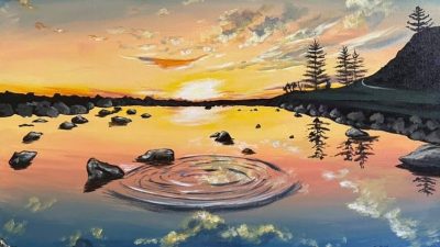  Badhan Das' "A Pebble's Disturbance Catching Eyes in a Tranquil Sunset" is an acrylic painting on canvas. In the foreground is a body of water, rings expanding from where a pebble was thrown into the water. A few rocks are visible and the surface reflects a pinky-orange sunset. In the background, the sun is just beginning to lower beyond the horizon, and a mountain with a few pine trees is visible to the right.