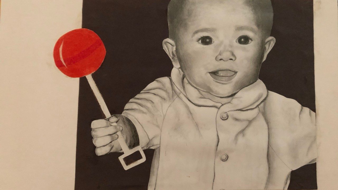  A charcoal, graphite, and colored pencil drawing by Riley Leathem of a white baby in a white onesie, holding a red rattle.