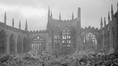  A black and white photograph of the  destroyed Coventry Cathedral after an air raid.