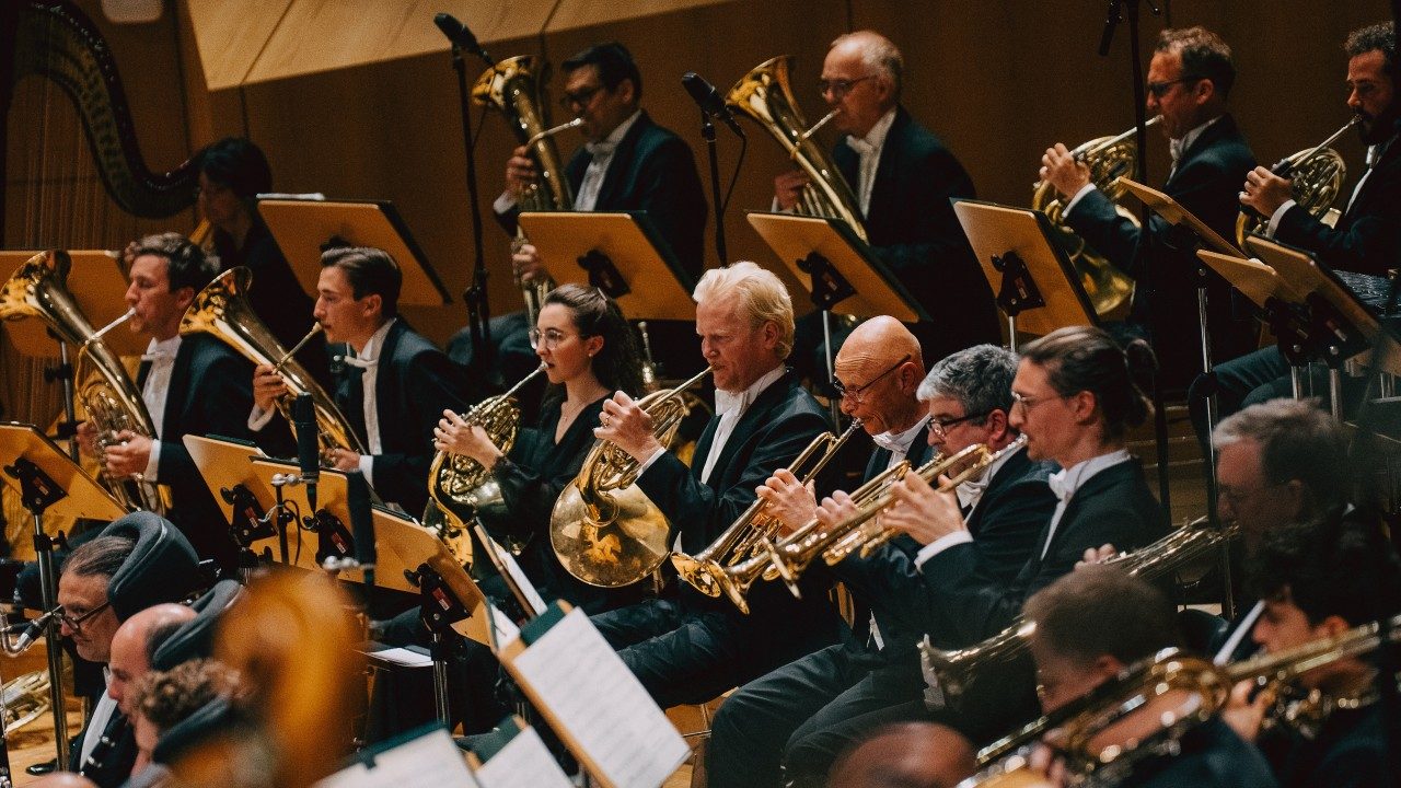  Members of Bamberg Symphony horn section play during a live performance.