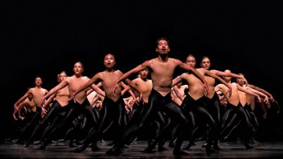Members of Ballet BC wear sheer nude tops and black pants as they perform BOLERO X.