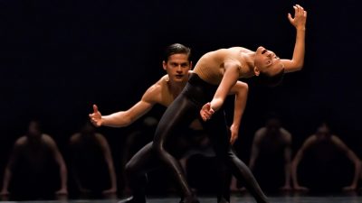 Members of Ballet BC wear sheer nude tops and black pants as they perform BOLERO X.