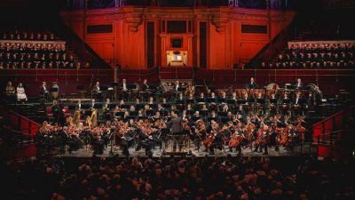 The Royal Philharmonic Orchestra performs a concert on stage.