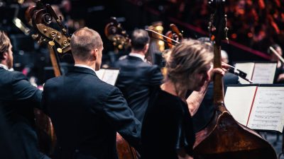 Members of the Royal Philharmonic Orchestra prepare to play on stage just before a concert.