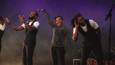 Members of Step Afrika! elicit cheers from the crowd during a performance on stage.