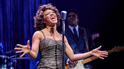 A cast member of "TINA – The Tina Turner Musical" performs on stage.
