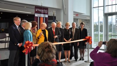 Former Virginia Tech President Charles Steger, center, prepares to cut the ribbon at the Moss Arts Center, surrounded by Virginia Tech and state officials and donors.